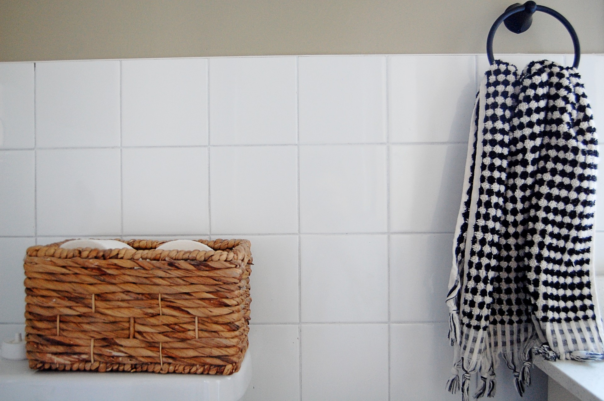 Close up of wall tile in a bathroom that's been recently painted.